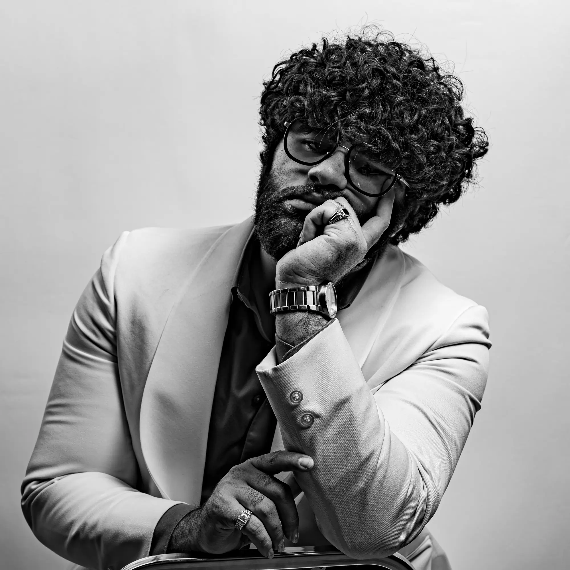 Nvar J.M. Sinclair, founder of NVAR Studios and CSWC USA leaderboard leader, in a white tuxedo — black and white editorial portrait