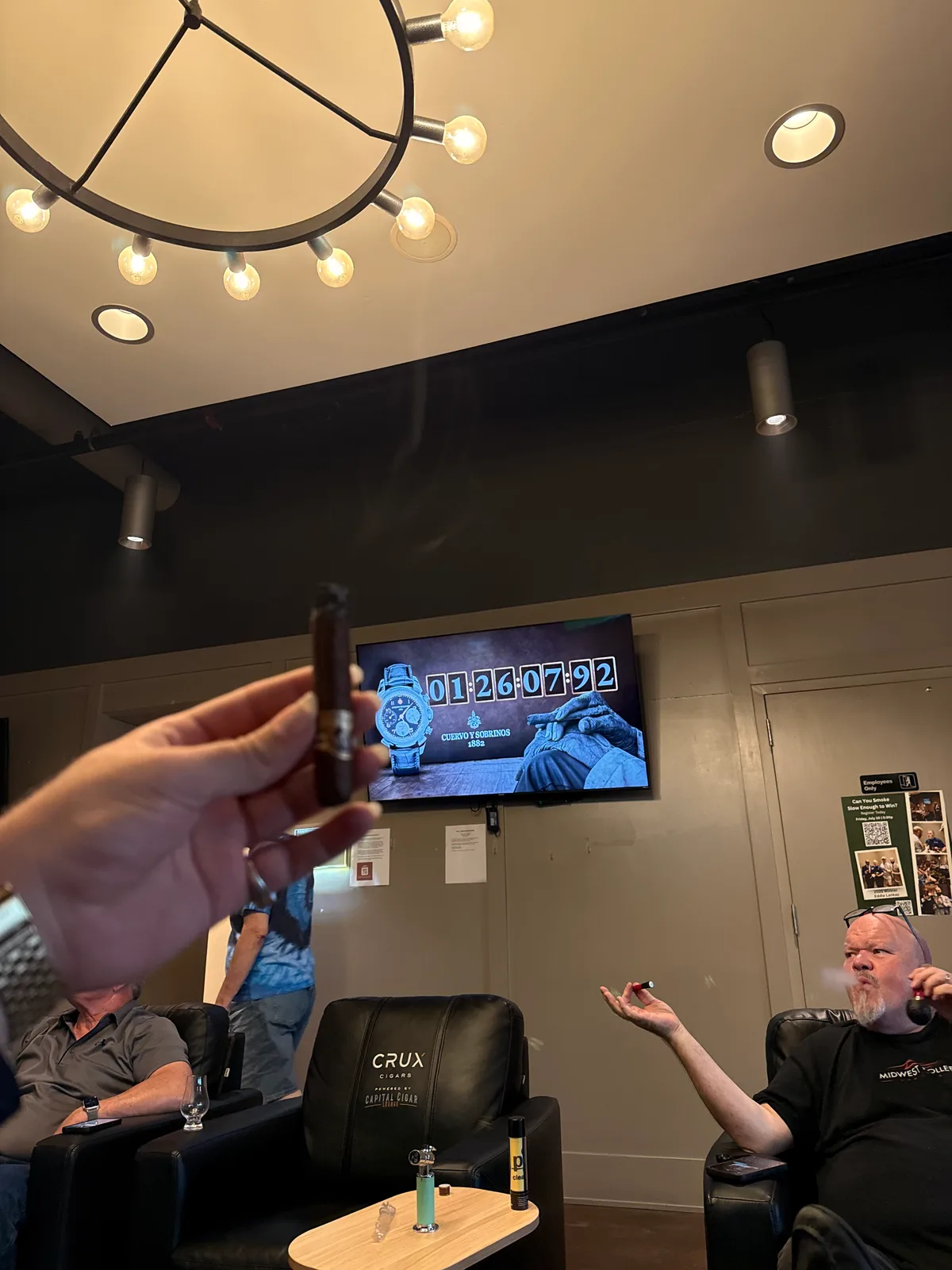 Competitor point of view mid-smoke: cigar in hand with the official competition timer at 1:26:07 on screen